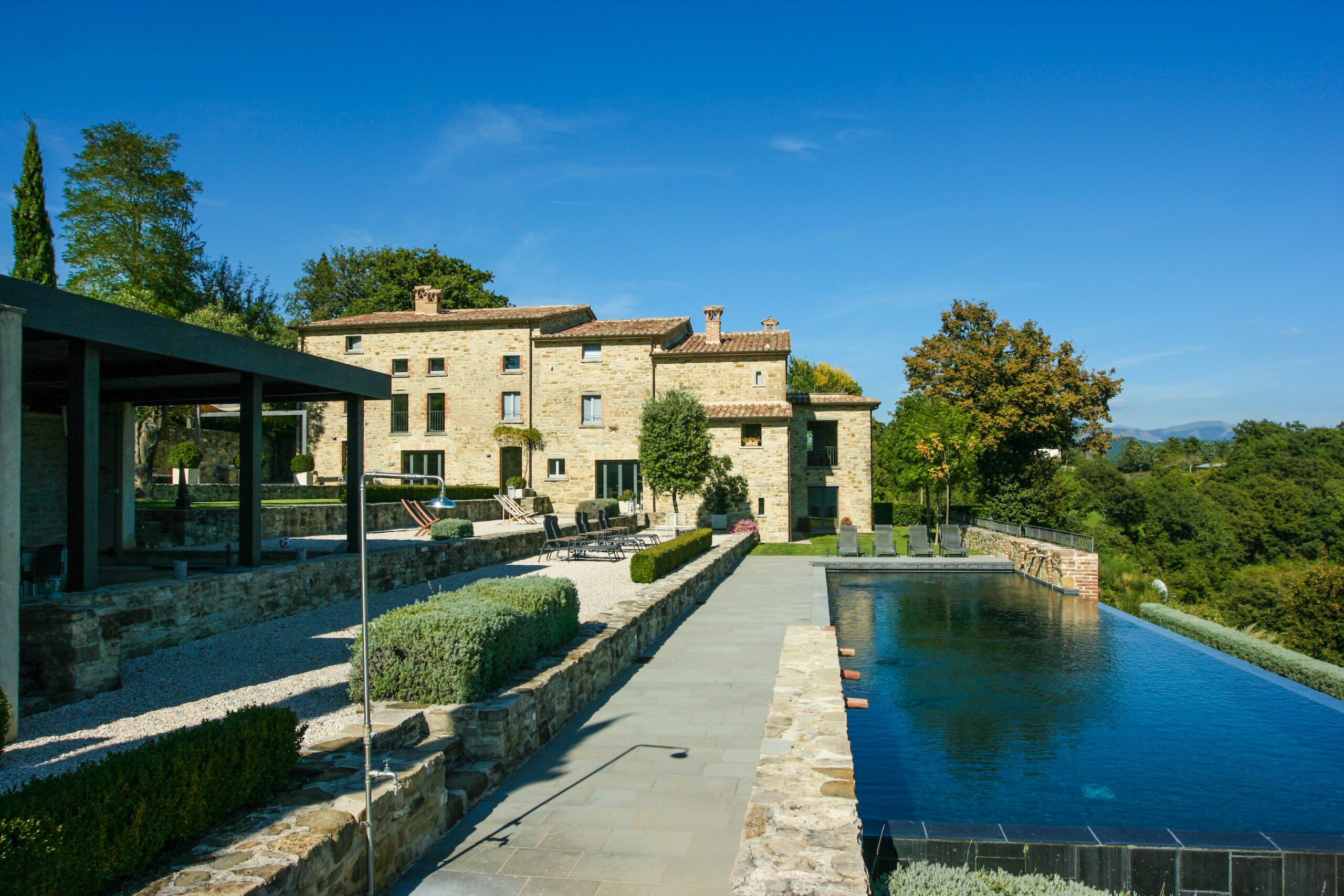 Side facade of Caidominici Villa with pool in Pietralunga, Italy