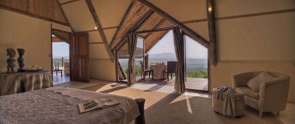 Bedroom with balcony in Cottar's Bush Villa in the Maasai Mara area in Kenya